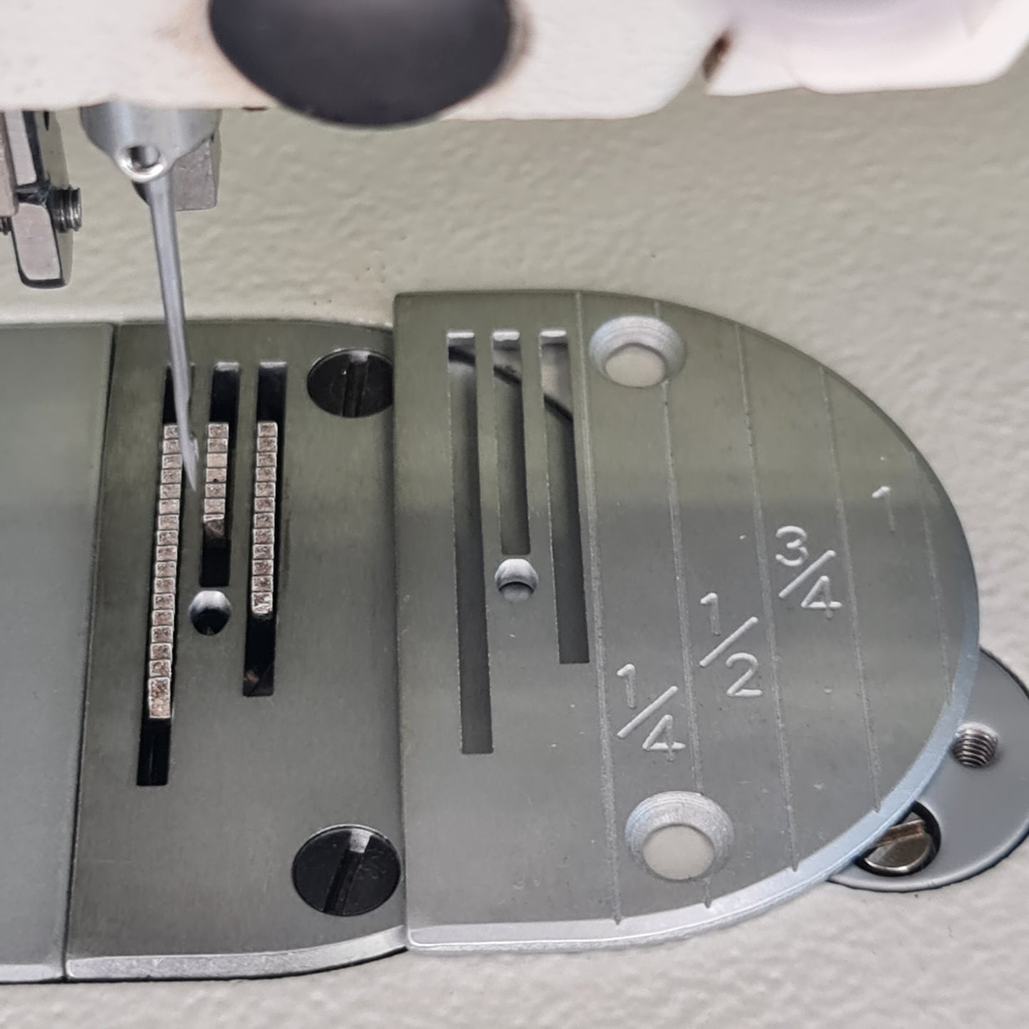 Marked needle plate for walking foot machine