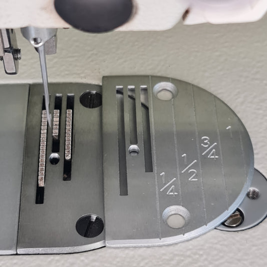 Marked needle plate for walking foot machine