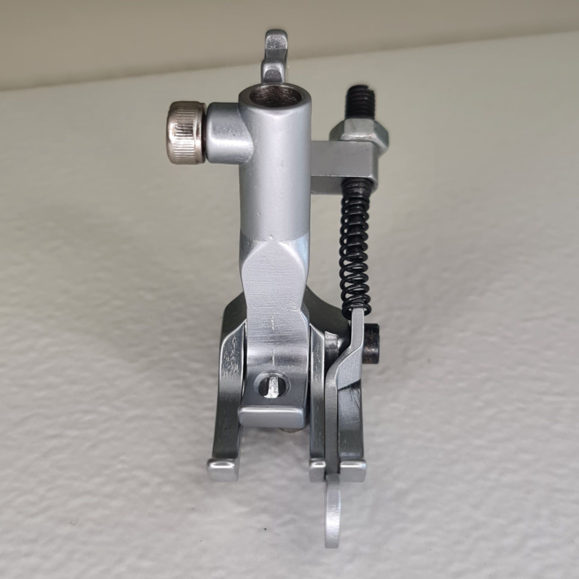 Front view of 1/4" topstitch presser foot for compound feed machines