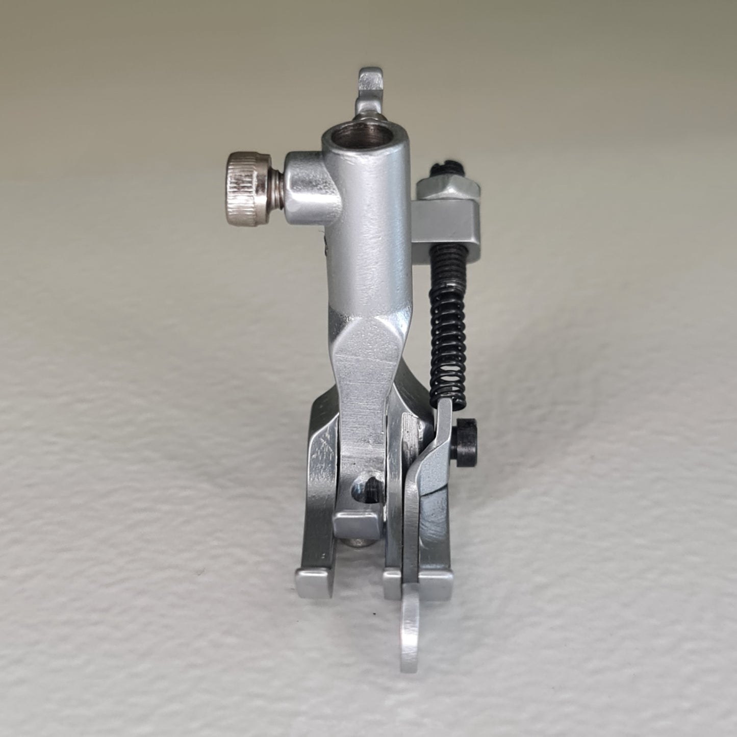 Front view of topstitch one-eighth-inch presser foot for compound feed machines